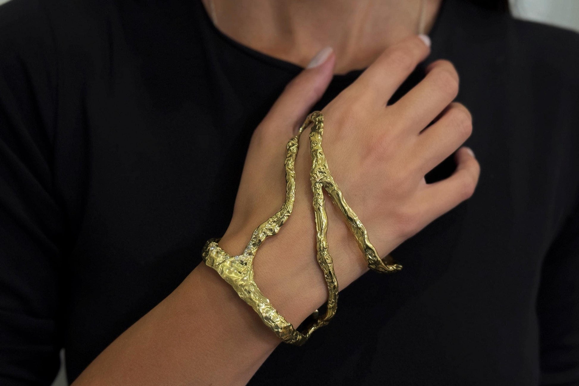 Golden brass bracelet on a person's wrist