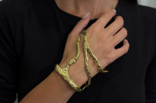 Golden brass bracelet on a person's wrist