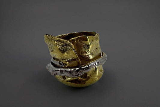 Goldeb brass ring on a dark gray background